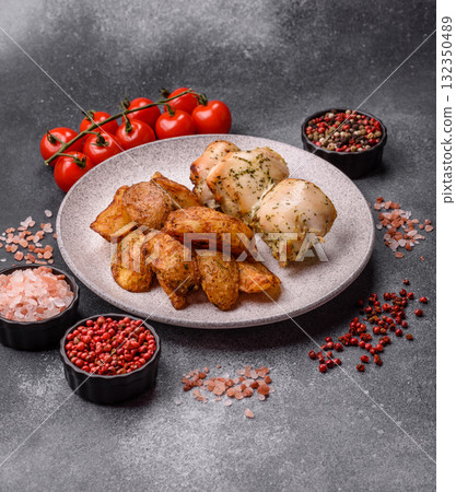 Potato wedges baked with spices, garlic and rosemary. Potato wedges 132350489