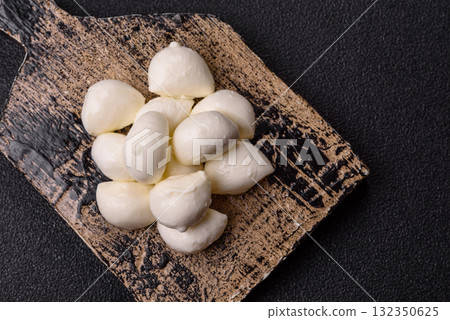 Mozzarella cheese balls, fresh white mini slices for Mediterranean food. Mozzarella cheese Mozzarella cheese balls, fresh white mini slices for Mediterranean food. Mozzarella cheese 132350625