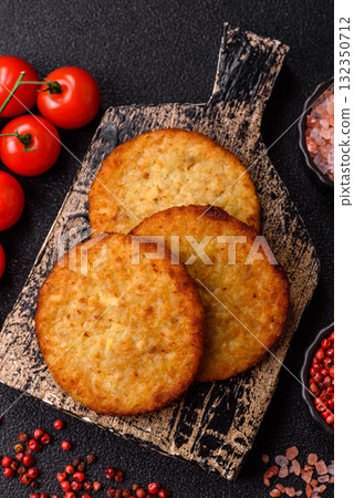 Hash browns, fried potato and onion pancakes with spices for breakfast. Fried hash browns Hash browns, fried potato and onion pancakes with spices for breakfast. Fried hash browns 132350712