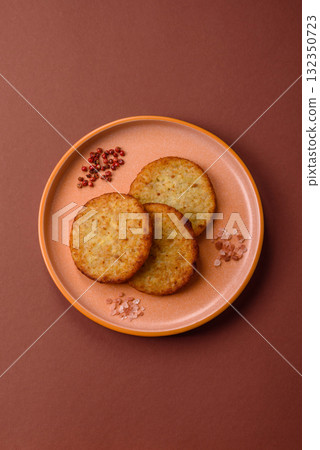 Hash browns, fried potato and onion pancakes with spices for breakfast. Fried hash browns Hash browns, fried potato and onion pancakes with spices for breakfast. Fried hash browns 132350723