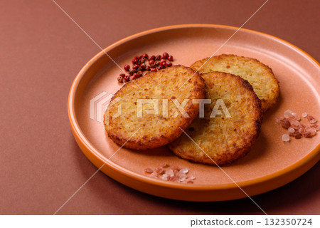 Hash browns, fried potato and onion pancakes with spices for breakfast. Fried hash browns Hash browns, fried potato and onion pancakes with spices for breakfast. Fried hash browns 132350724