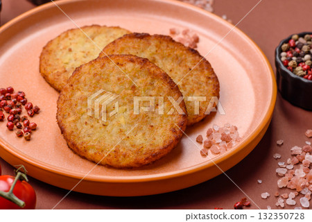 Hash browns, fried potato and onion pancakes with spices for breakfast. Fried hash browns Hash browns, fried potato and onion pancakes with spices for breakfast. Fried hash browns 132350728