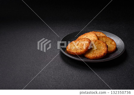 Hash browns, fried potato and onion pancakes with spices for breakfast. Fried hash browns Hash browns, fried potato and onion pancakes with spices for breakfast. Fried hash browns 132350736