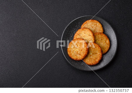 Hash browns, fried potato and onion pancakes with spices for breakfast. Fried hash browns Hash browns, fried potato and onion pancakes with spices for breakfast. Fried hash browns 132350737