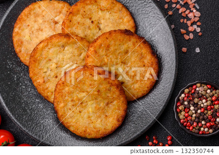 Hash browns, fried potato and onion pancakes with spices for breakfast. Fried hash browns Hash browns, fried potato and onion pancakes with spices for breakfast. Fried hash browns 132350744