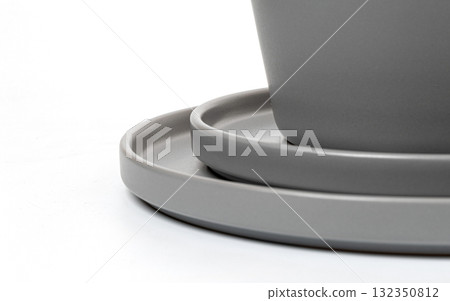 Stacked grey ceramic plates and bowl on white background 132350812