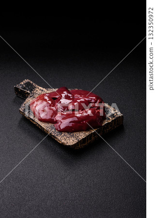 Raw fresh chicken or turkey liver, internal offal of poultry. Raw chicken liver Raw fresh chicken or turkey liver, internal offal of poultry. Raw chicken liver 132350972