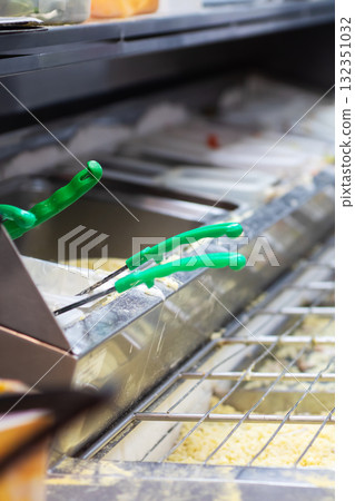 A Detailed CloseUp Image of Tongs in a Commercial Kitchen Setup A Detailed CloseUp Image of Tongs in a Commercial Kitchen Setup 132351032