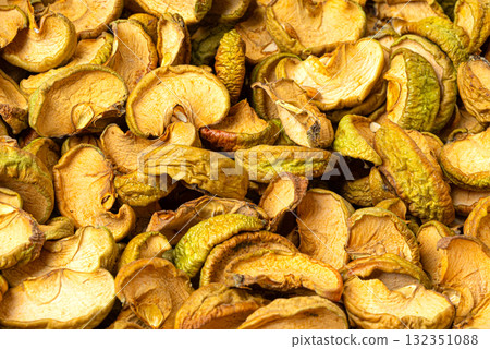 Dried apple slices creating healthy sweet snack background 132351088