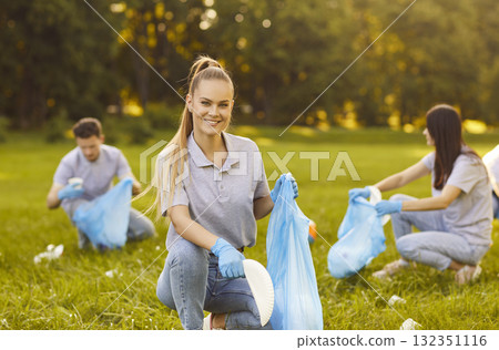 Picking up trash cleaning green park, group friends people working, wearing blue gloves, bags 132351116