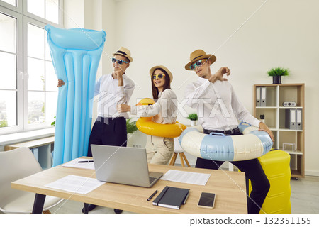 Overjoyed company employees going on summer holidays booking tickets in office. 132351155