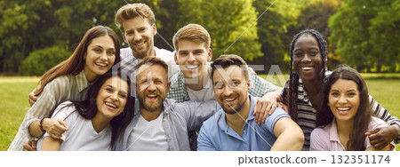 Group portrait of happy cheerful young diverse friends together in green summer park 132351174