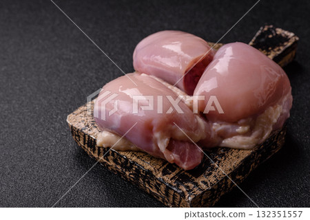 Chicken or turkey raw thigh fillet, skinless and boneless poultry meat. Chicken thigh fillet Chicken or turkey raw thigh fillet, skinless and boneless poultry meat. Chicken thigh fillet 132351557
