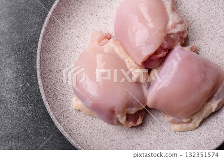Chicken or turkey raw thigh fillet, skinless and boneless poultry meat. Chicken thigh fillet Chicken or turkey raw thigh fillet, skinless and boneless poultry meat. Chicken thigh fillet 132351574