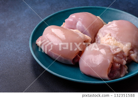 Chicken or turkey raw thigh fillet, skinless and boneless poultry meat. Chicken thigh fillet Chicken or turkey raw thigh fillet, skinless and boneless poultry meat. Chicken thigh fillet 132351588