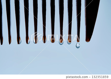 A comb with hair serum. The photo shows the texture of the cosmetic product. A comb with hair serum. The photo shows the texture of the cosmetic product. 132351859