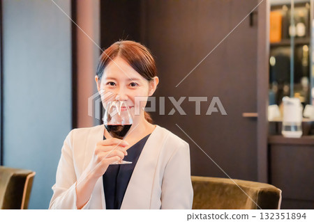 Young woman enjoying the aroma of wine 132351894