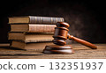A wooden judge's gavel and a stack of law books on a wooden table, brown background. Concept of law, equality, and justice. Law office, legal and forensic 132351937
