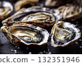 A close-up of fresh oysters salt and ice on a black surface, details. Concept of seafood, shell texture 132351946