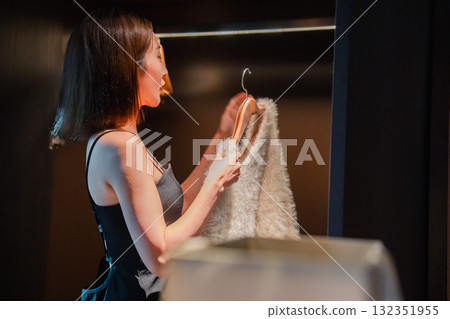 A young woman arriving at a luxury hotel and getting changed 132351955