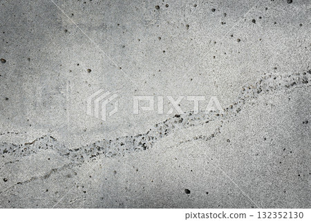 Light gray concrete wall with a thin curved crack. Natural grunge stone texture and background for posters, banners and typography. 132352130