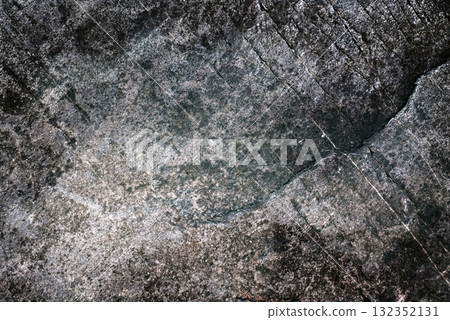 Dark-gray grainy rock surface with diagonal micro-cracks, granite-like. High-contrast grunge texture and stone background for posters, banners and web graphics. Dark-gray grainy rock surface with diagonal micro-cracks, granite-like. High-contrast grunge texture and stone background for posters, banners and web graphics. 132352131