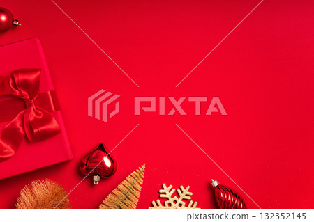 Clean red background with a gift box and ribbon bow at the bottom. Very large copy space for banners, headers, seasonal promotions and greetings - perfect for simple layouts. Clean red background with a gift box and ribbon bow at the bottom. Very large copy space for banners, headers, seasonal promotions and greetings - perfect for simple layouts. 132352145