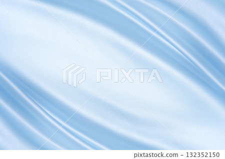 Glossy satin folds in light blue with diagonal flow and highlights. Luxury background for cosmetics, weddings and holiday branding. 132352150