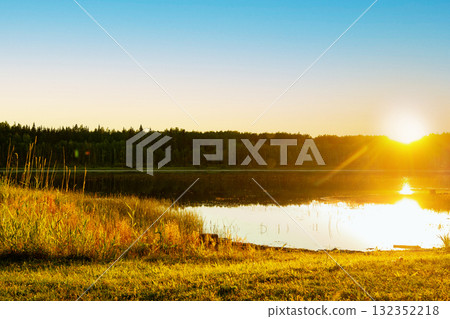 Beautiful scene at the lake in the woods, golden sunset light. Beautiful scene at the lake in the woods, golden sunset light. 132352218