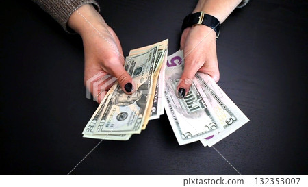 Woman counting money for savings and expenses 132353007