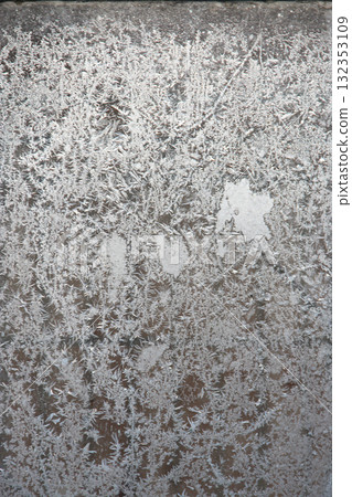 Patterns on the window in winter. Winter drawing on the window. Natural pattern 132353109