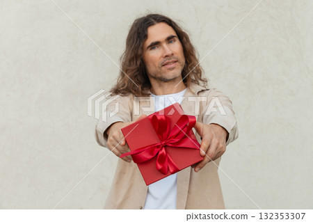 Happy handsome caucasian man giving red gift box with love. Birthday. Romantic surprise and celebration. Greeting card. 132353307