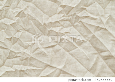 Close up shot of crumpled fabric. Beige natural cotton fabric with many wrinkles, texture background 132353339