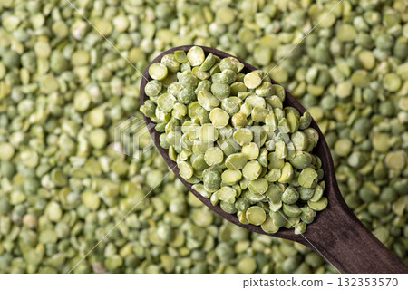Background of green pea in dark wooden spoon. Green dry pea background, cooking with pea Background of green pea in dark wooden spoon. Green dry pea background, cooking with pea 132353570