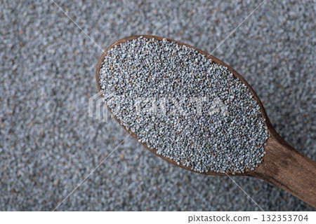 Dark wooden spoon with poppy seed. Harvested poppy seed close up Dark wooden spoon with poppy seed. Harvested poppy seed close up 132353704