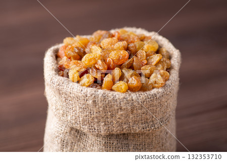 Small fancy bag full of raisins. Tasty raisins made of high quality grapes 132353710