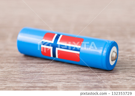 Rechargeable battery with flag of Norway on table. Origin of battery, produce accumulators in Norway Rechargeable battery with flag of Norway on table. Origin of battery, produce accumulators in Norway 132353729
