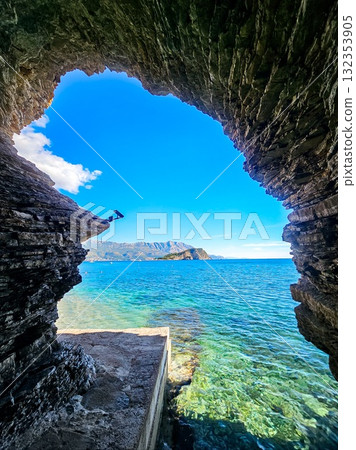 Adriatic Sea and Hawaii Island seen through the entrance of a coastal cave in Budva, Montenegro. Scenic natural panorama. 132353905