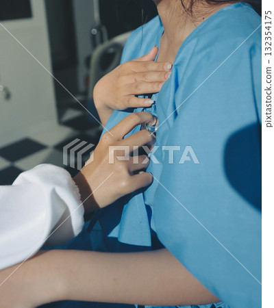 healthy concept; Doctor checking patient's heart with stethoscope at a hospital healthy concept; Doctor checking patient's heart with stethoscope at a hospital 132354175
