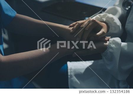 Male doctors shake hands with patients encouraging each other and praying for blessings. To offer love, concern, and encouragement while checking the patient's health. concept of medicine Male doctors shake hands with patients encouraging each other and praying for blessings. To offer love, concern, and encouragement while checking the patient's health. concept of medicine 132354186
