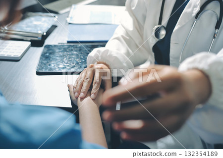 Male doctors shake hands with patients encouraging each other and praying for blessings. To offer love, concern, and encouragement while checking the patient's health. concept of medicine 132354189