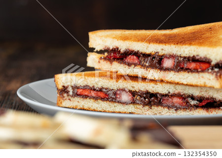 Sandwich toast with chocolate paste and cut strawberry Sandwich toast with chocolate paste and cut strawberry 132354350