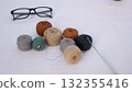 Many skeins with cotton crochet threads on the table in brown-gray tones 132355416