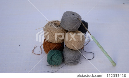 There are many balls with threads of different colors on the table 132355418