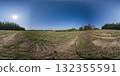 360 degree panorama of a field with rows of mown wheat, hills, and forest on the horizon. A seamless spherical 360-degree HDRI panorama of field 132355591
