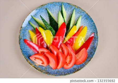 A colander filled with assorted fresh ripe tomatoes, red, heirloom, beef heart, pear shaped and cherry varieties with fresh basil. Rustic, farm to table aesthetic, harvest and cooking concept 132355692