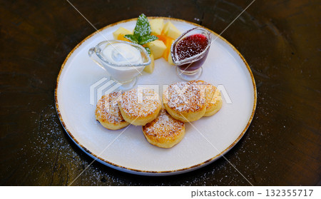 Pancakes for breakfast with sour cream, raspberry jam and fresh raspberries. Pancakes for breakfast with sour cream, raspberry jam and fresh raspberries. 132355717