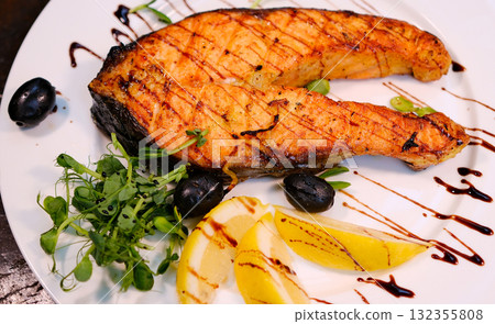 Grilled salmon steak over grilled asparagus, a delicious and healthy meal Grilled salmon steak over grilled asparagus, a delicious and healthy meal 132355808