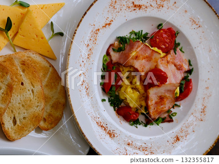 Breakfast sandwich with fried egg, bacon and green sprouts on white background, top view, copy space. Fried sunny side egg with bacon on toast with microgreens and morning cappuccino coffee. Breakfast sandwich with fried egg, bacon and green sprouts on white background, top view, copy space. Fried sunny side egg with bacon on toast with microgreens and morning cappuccino coffee. 132355817