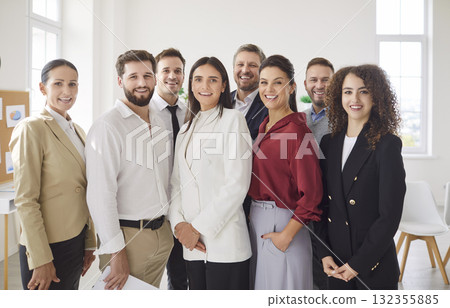 Diverse team portrait of happy business employees meeting in office, standing looking at camera 132355885